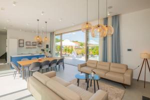 a living room with a couch and a table at Luxury Villa Blue with a pool in Zmijavci