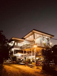 a large building at night with lights on it at บ้านบนภู ปากช่อง พลูวิลล่า in Ban Lam Thong Lang