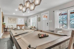 a living room with a pool table in it at 4Bed/3bath- 1 mile to Downtown in Spartanburg