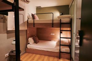 a small room with two bunk beds in it at TOC Hotel Las Ramblas in Barcelona