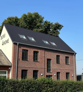 a red brick building with solar panels on it at Ferienwohnungen Hamminkeln, Berg4Home in Hamminkeln