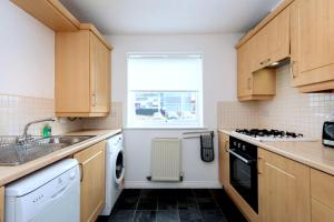 a kitchen with a sink dishwasher and a window at Hindmarsh Apartment in Ashington +24 photos
