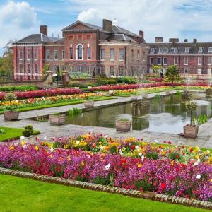 a garden with flowers in front of a building at 3-Bedroom Flat with FREE parking in the Heart of Hampton Hill Village in Hampton Hill