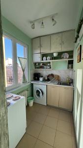a kitchen with a sink and a washing machine at Your Space in Sofia in Sofia