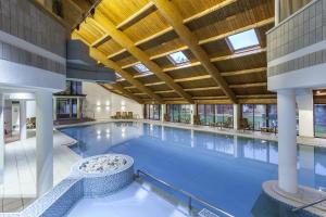 a large swimming pool with a ceiling with skylights at Langdale Cottage - 5 bedrooms and 5 bathrooms in Chapel Stile