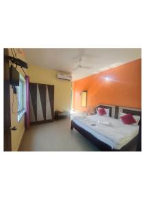 a bedroom with a bed in a room at Goroomgo D2 Holiday inn Near Sea Beach in Puri