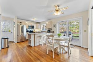 a kitchen and dining room with a table and chairs at The Burkeshire Manor - Charming Family Home in Oak Bluffs