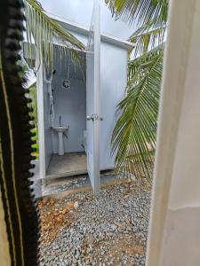 a bathroom with a toilet through a door at The Coco Journey - Eco Tent in Kelebang Besar