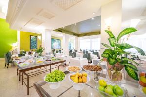 a dining room with tables filled with fruits and vegetables at Hotel Terme Delle Nazioni in Montegrotto Terme