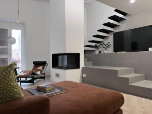a living room with a tv and a staircase at Le Camere dell’Emiro in Castronuovo di Sicilia