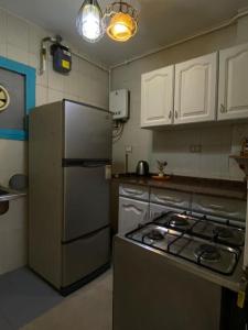 a kitchen with a refrigerator and a stove in it at Rehab serenity in Cairo