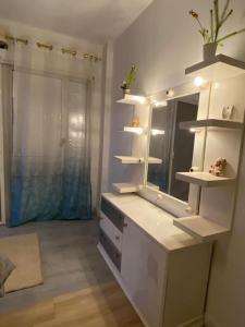 a bathroom with a white vanity with a mirror at Rehab serenity in Cairo