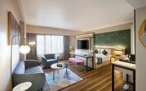 a hotel room with a bed and a desk at Hotel Suba International in Mumbai