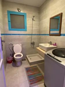 a bathroom with a toilet and a sink and a mirror at Rehab serenity in Cairo