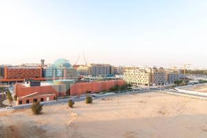 an aerial view of a city with buildings and a beach at Spectacular 2 Bedroom In Oasis in Al Qurayyah