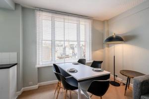 a dining room with a white table and chairs at Quiet and Peaceful House near Marble Arch in London