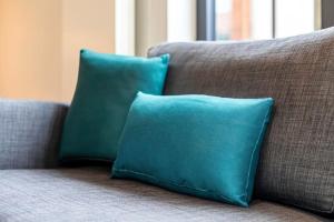 two blue pillows are sitting on a couch at Quiet and Peaceful House near Marble Arch in London