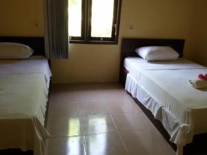 Postel nebo postele na pokoji v ubytování Syifa Homestay