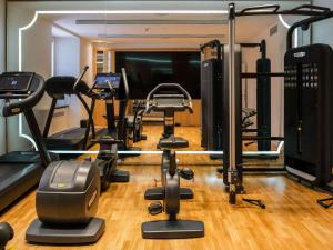 a gym with treadmills and exercise equipment in a room at Sofitel Roma Villa Borghese in Rome
