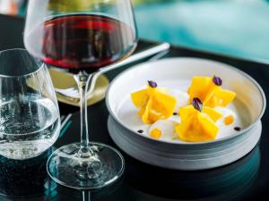 a plate of food next to a glass of wine at Sofitel Roma Villa Borghese in Rome