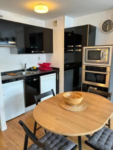 a kitchen with a wooden table with a bowl on it at Apartamento Astun in Astun 