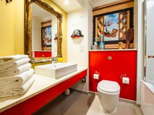 a bathroom with a red vanity and a white toilet at LEGOLAND(R) Windsor Resort in Windsor