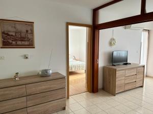 a living room with a tv and a room with a bed at Apartment Banko in Umag