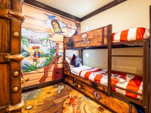 a bedroom with two bunk beds with a disney mural at LEGOLAND(R) Windsor Resort in Windsor