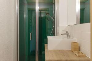 a bathroom with a sink and a glass shower at Appartement Mer de Glace 7 - Happy Rentals in Chamonix-Mont-Blanc