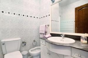 ein weißes Badezimmer mit Waschbecken und Toilette in der Unterkunft A O - Apartamento Aires in Peniche + 14 Fotos