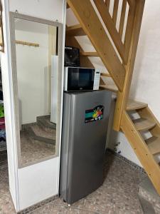 a small refrigerator with a microwave on top of it at Itaca in Lipari