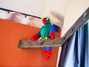 a toy parrot sitting on a wooden branch at LEGOLAND(R) Windsor Resort in Windsor