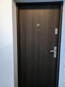 a wooden door with the number on it at Apartament EM in Krosno
