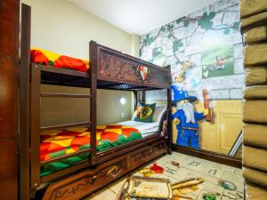 a childs bedroom with two bunk beds and a mural at LEGOLAND(R) Windsor Resort in Windsor