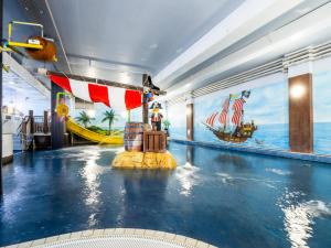 a pool on a cruise ship with a water slide at LEGOLAND(R) Windsor Resort in Windsor