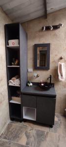 ein Bad mit einem schwarzen Waschtisch und einem Waschbecken in der Unterkunft Cabaña el amarillo in Barbosa