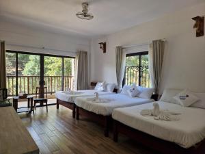 Postel nebo postele na pokoji v ubytování Butterfly Rose Beach Resort Phú Quốc Francophone