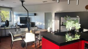 a kitchen with a table and a dining room at les templiers 