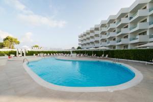 a large swimming pool in front of a building at THB Naeco Ibiza - Adults Only in San Antonio Bay