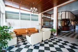 a living room with a couch and a checkered floor at THB Felip - Adults Only in Porto Cristo