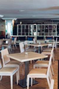 a group of tables and chairs in a restaurant at THB Dos Playas - Adults Only in Cala Ratjada