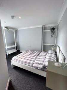 a bedroom with a bed and a lamp and a desk at Prime Backpackers Angel in London