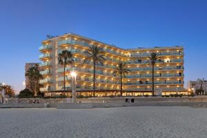 a large building with palm trees in front of it at THB El Cid - Adults Only in Can Pastilla
