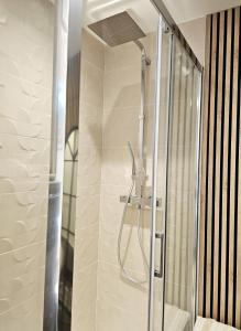 a shower with a glass door in a bathroom at Appartement Cocooning in Fréjus +11 photos