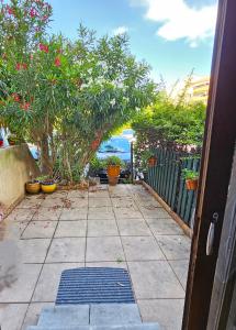 an entrance to a yard with potted plants and a fence at Appartement Cocooning in Fréjus