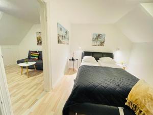 a bedroom with a bed and a living room at aday - Randers Elegant and Trendy Apartment in Randers