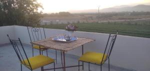 a table and chairs on a patio with a view at Dar marruecos in Kasba Mohammed Ou Addi