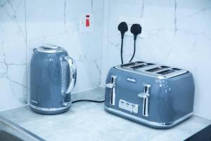 two toasters sitting on a counter next to a toaster at Superb 1-Bed Apartment in Harrow in Harrow