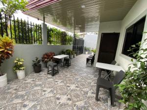 a patio with tables and chairs on a building at A&J Transient house (with wifi, Netflix & Disney+) in General Santos