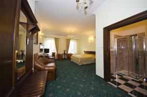 a hotel room with a bed and a bathroom at Royal Hotel Modlin in Nowy Dwór Mazowiecki